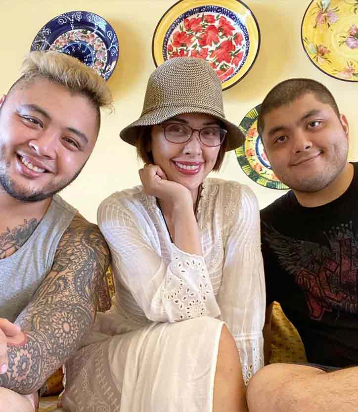 Filipina celebrity mom and sons in white