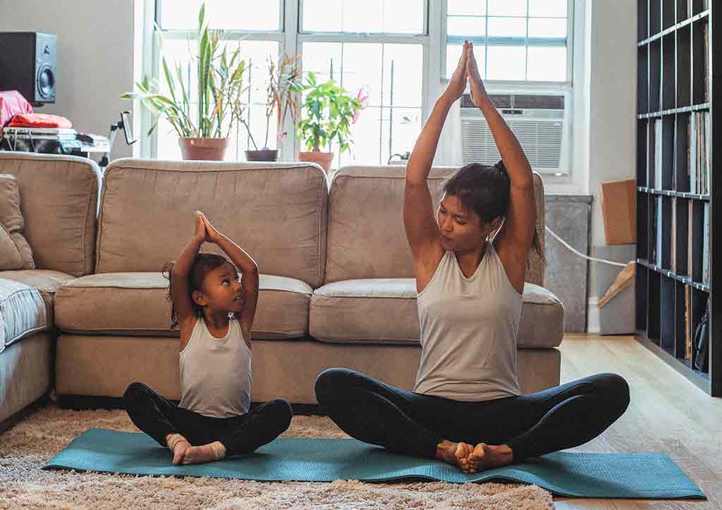 a girl and her mother exercising