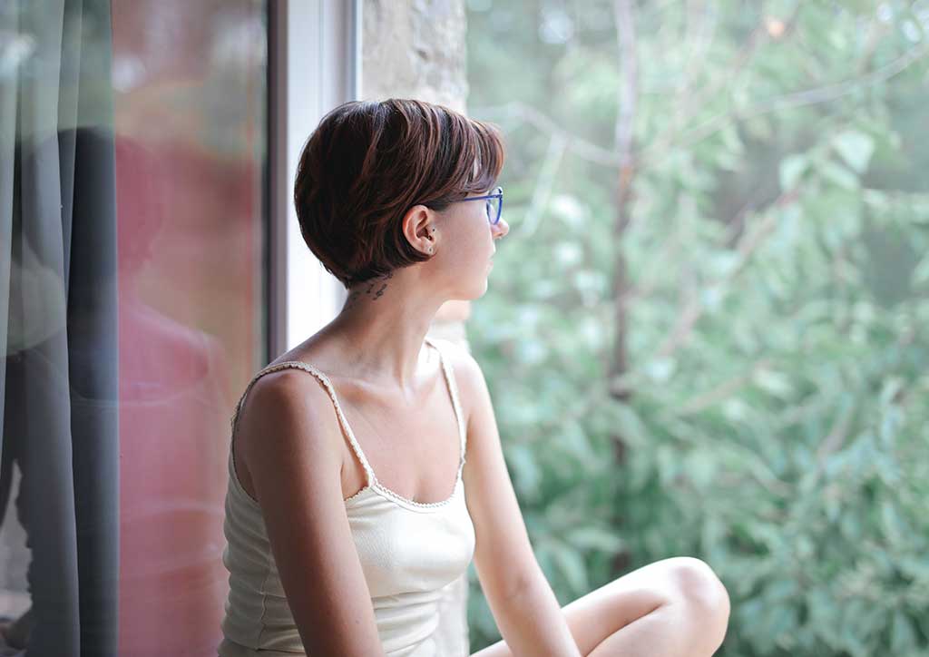 girl looking outside the window