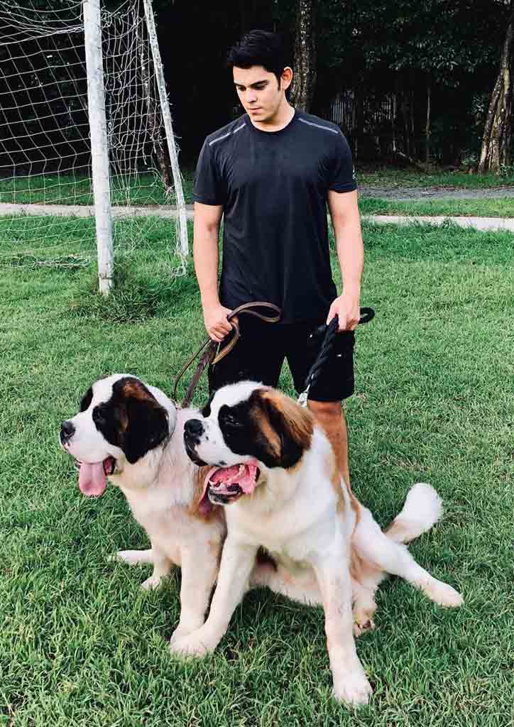 Male celebrity in black and his pet dog