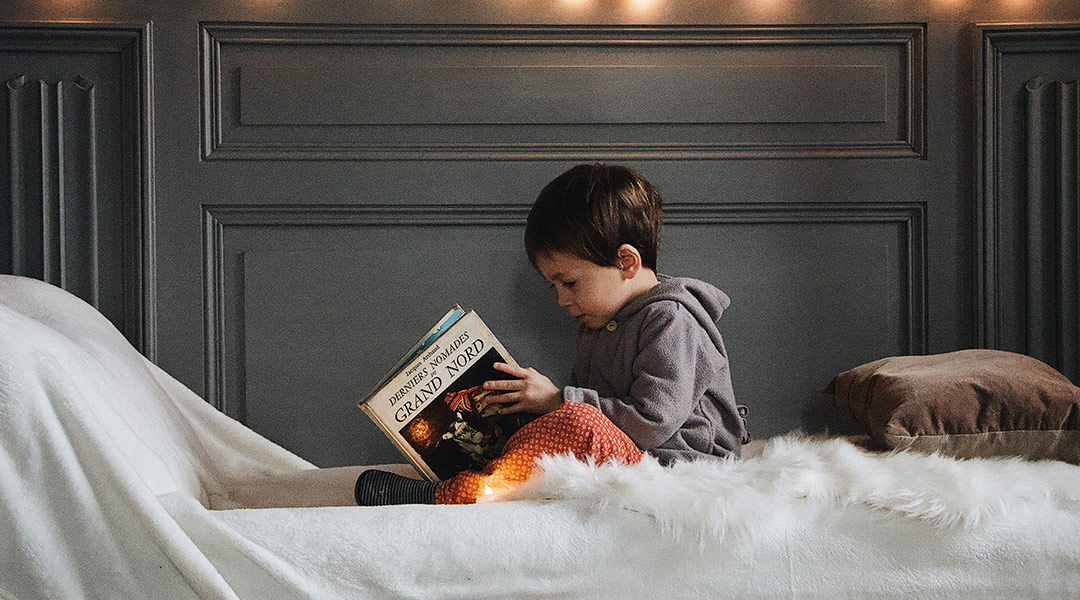 little boy reading a book
