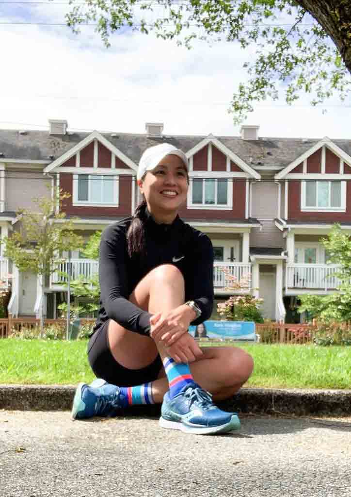 Girl in black running attire posing outdoors 