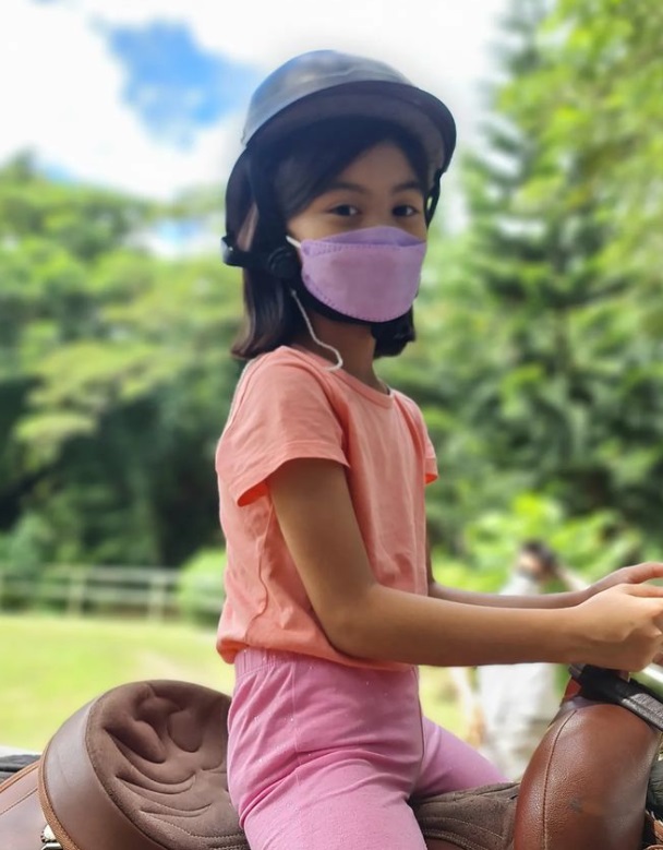 Lucia getting ready to fulfill her birthday wish: riding a horse. We're sure she's smiling under her mask!