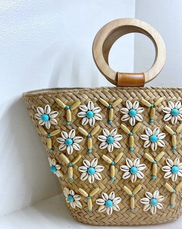 Matthew and Melka bag made with natural weaves, faceted turquoise, cowrie shells, wooden beads and handles with cowskin leather.