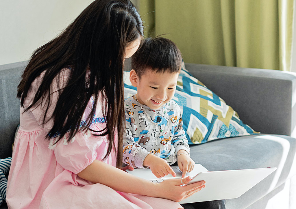 A mother teaching her son their mother tongue.