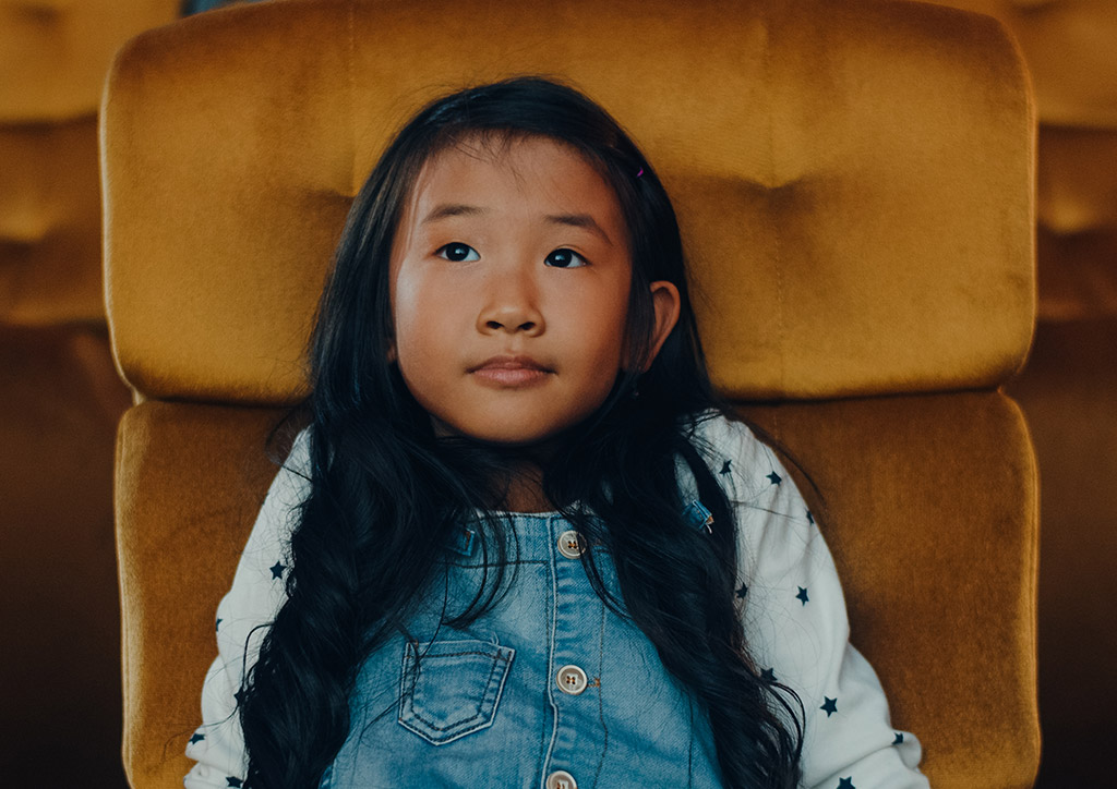 A kid watching a musical.