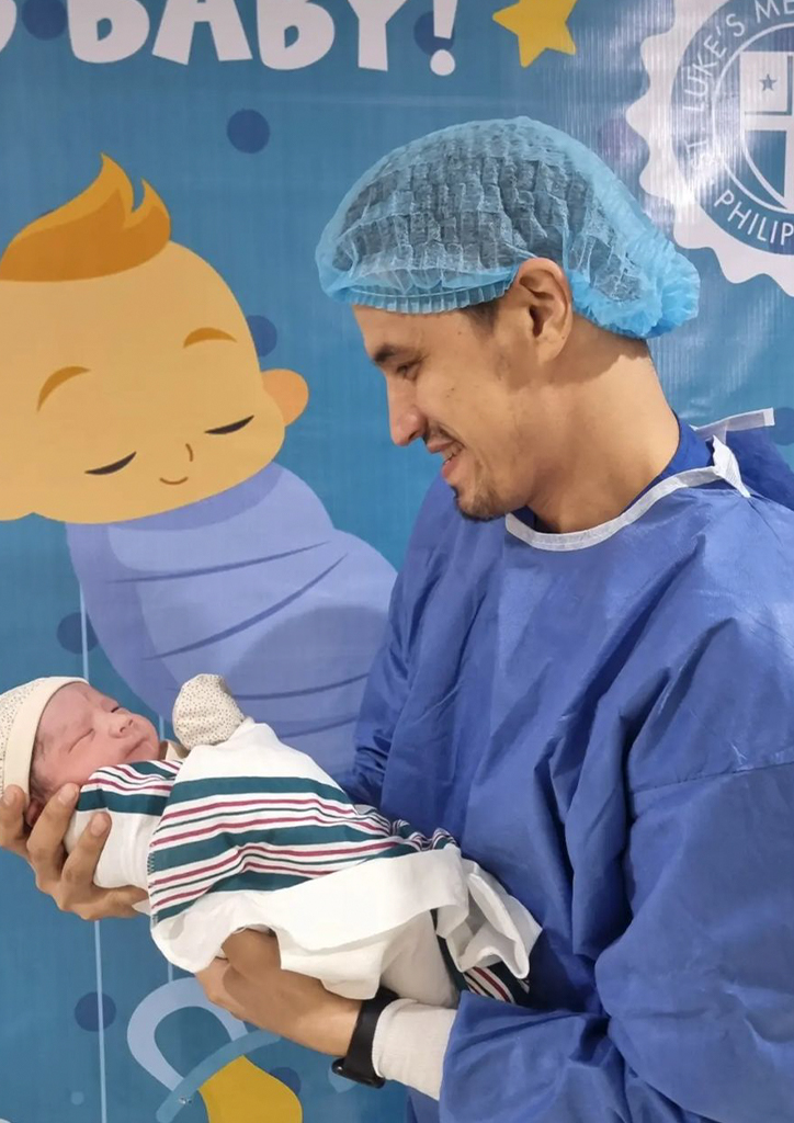 Marc Pingris carrying his son