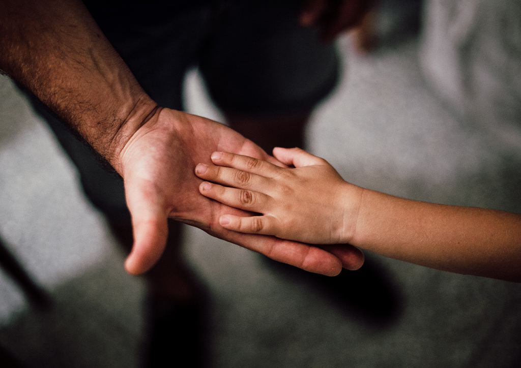 A father and son holding hands