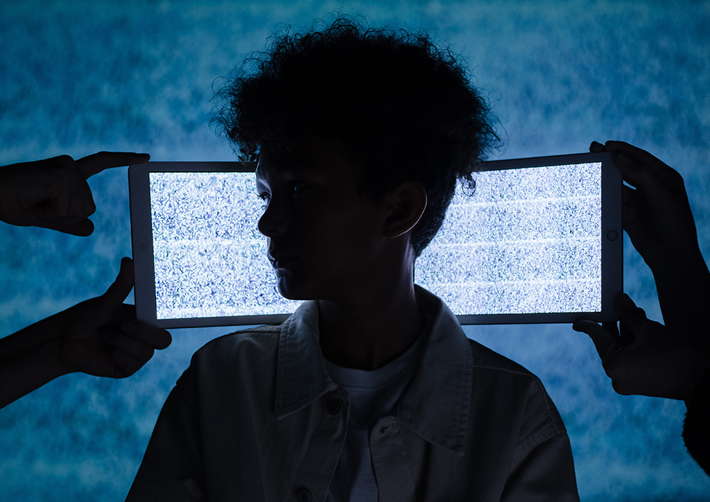 A child netizen with tablets in the background