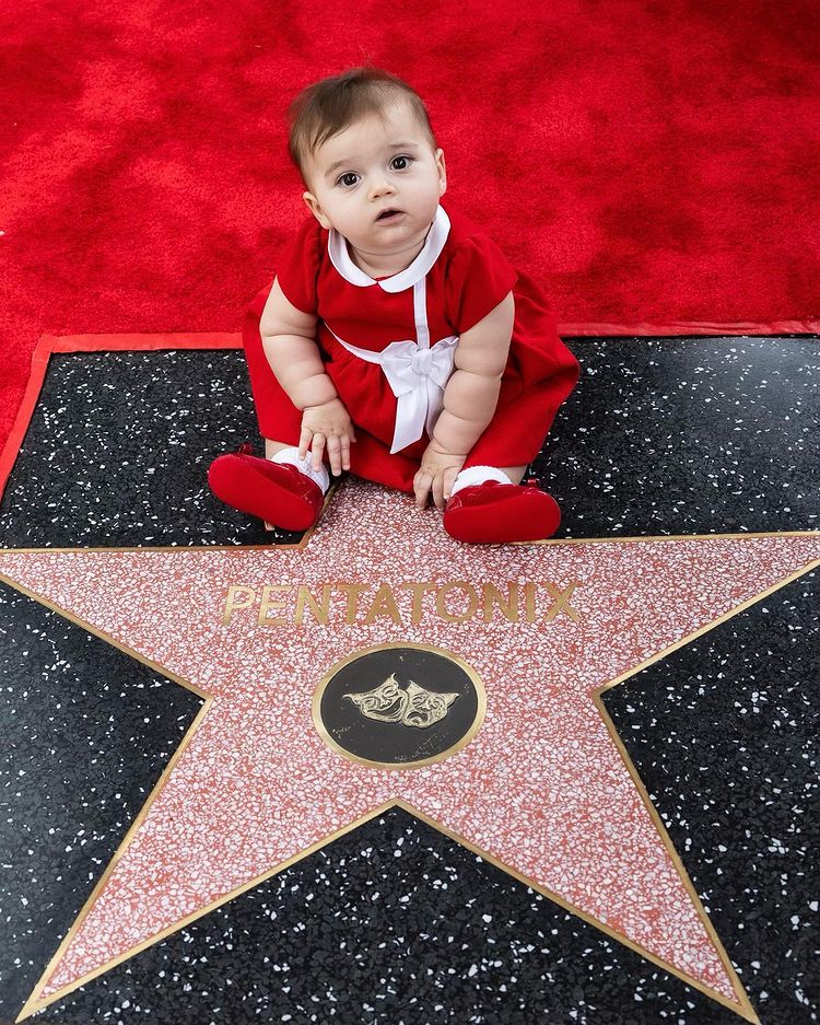 Pentatonix Kristen takes a picture of her daughter sitting with the Walk of Fame star