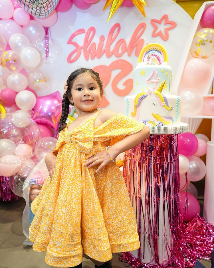 Rochelle Pangilinan gets a picture with her daughter, Shiloh, and the pink unicorn cake.