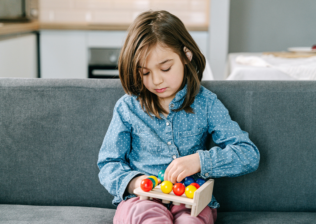 A girl playing silently by herself