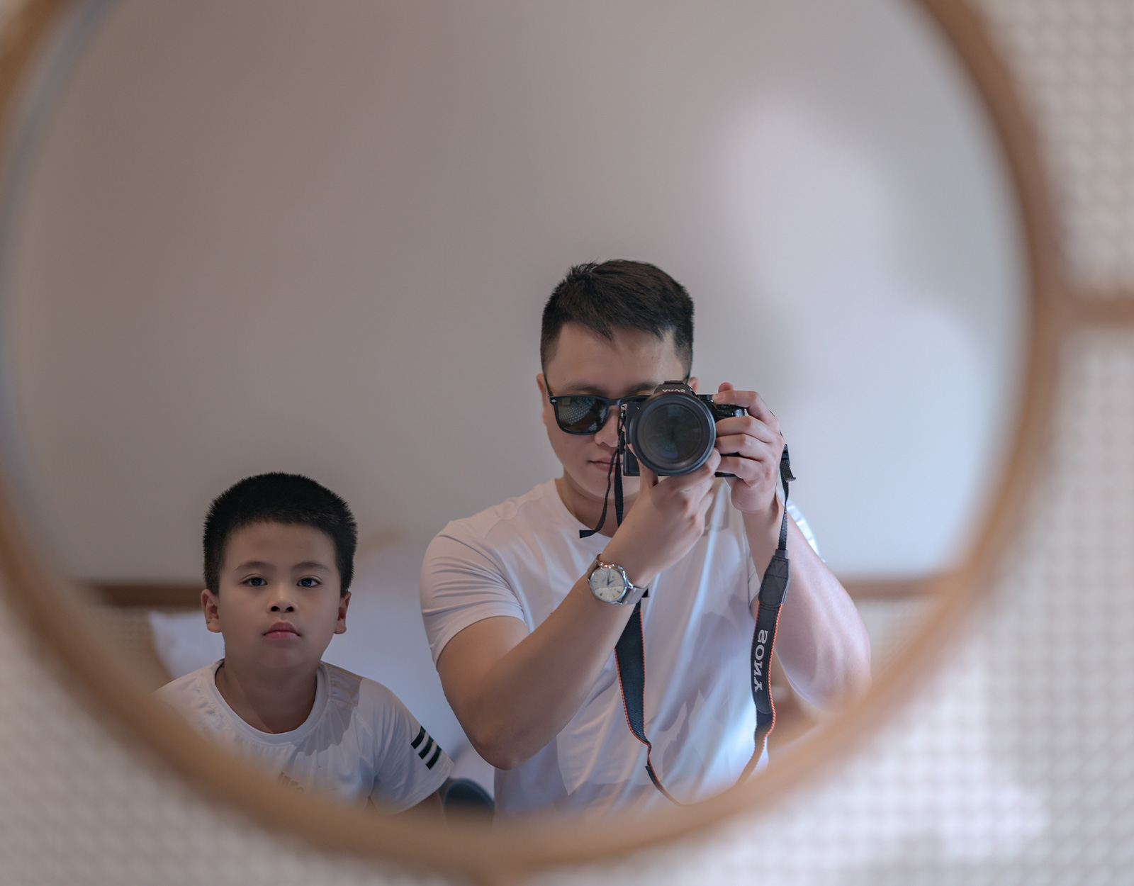 A father taking a photo of him and his son