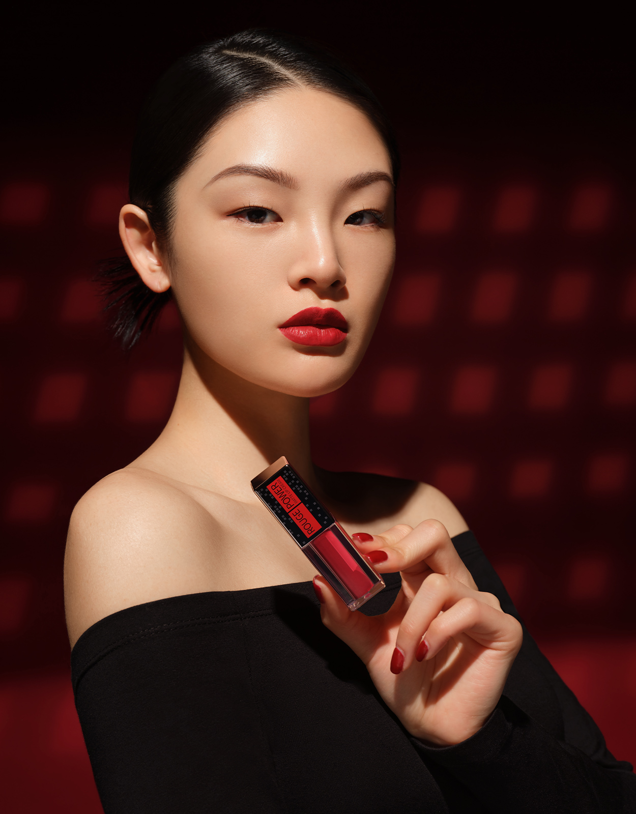 A woman holding Rouge Power Matte Lip Cream