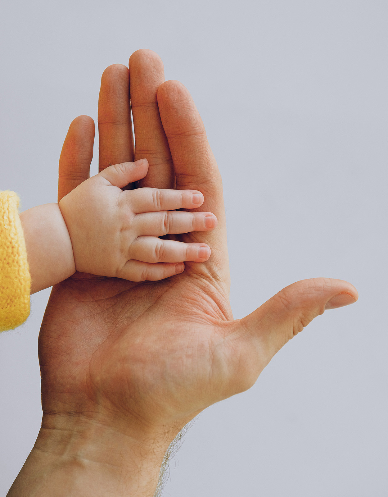 Hands of a mom and baby