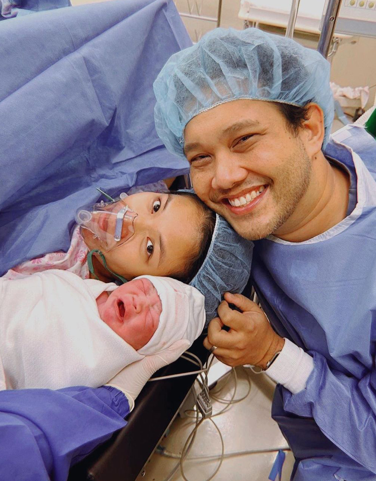 Quark Henares with his wife and son