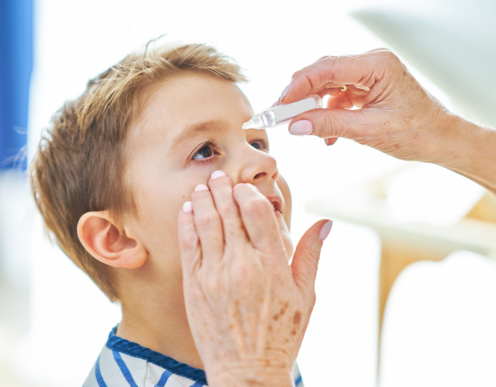 eyedrops on kid with sore eyes