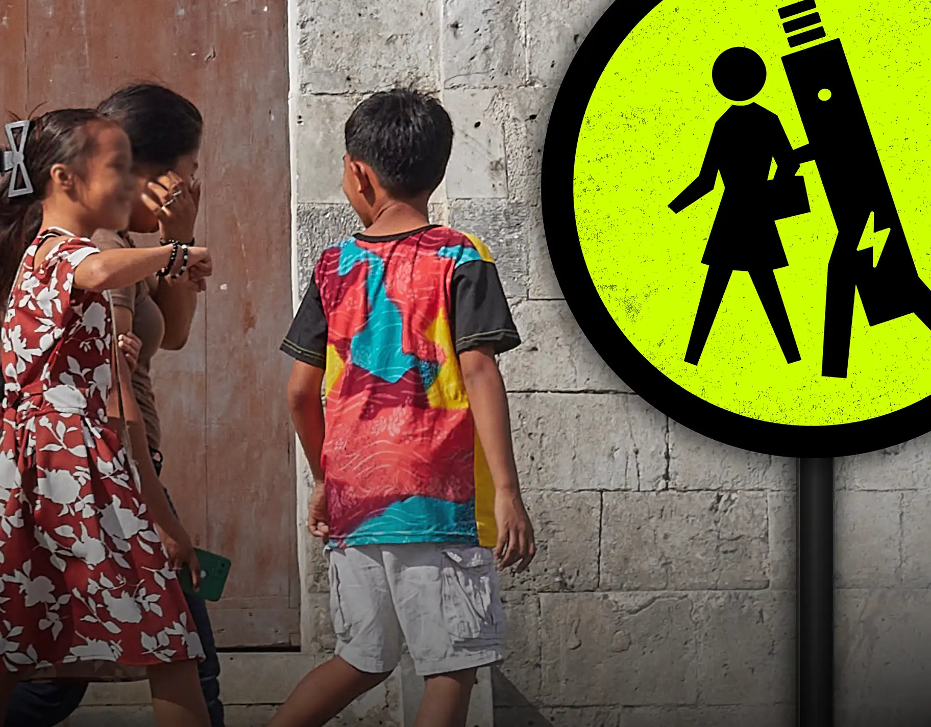A fluorescent yellow crossing sign depicting an electronic cigarette grabbing a student’s arm, juxtaposed with a photo of three school-aged Filipino children walking across a crosswalk.